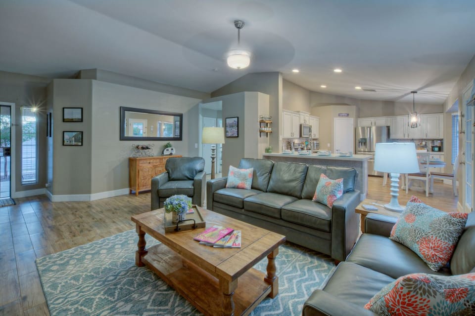 Open concept floor plan has vaulted ceilings and tile floors in all but two bedrooms.