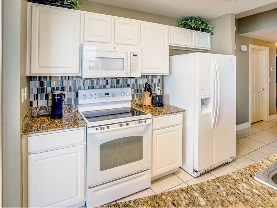 Your fully equipped kitchen features granite countertops, modern appliances, and everything you need to create memorable meals during your stay.