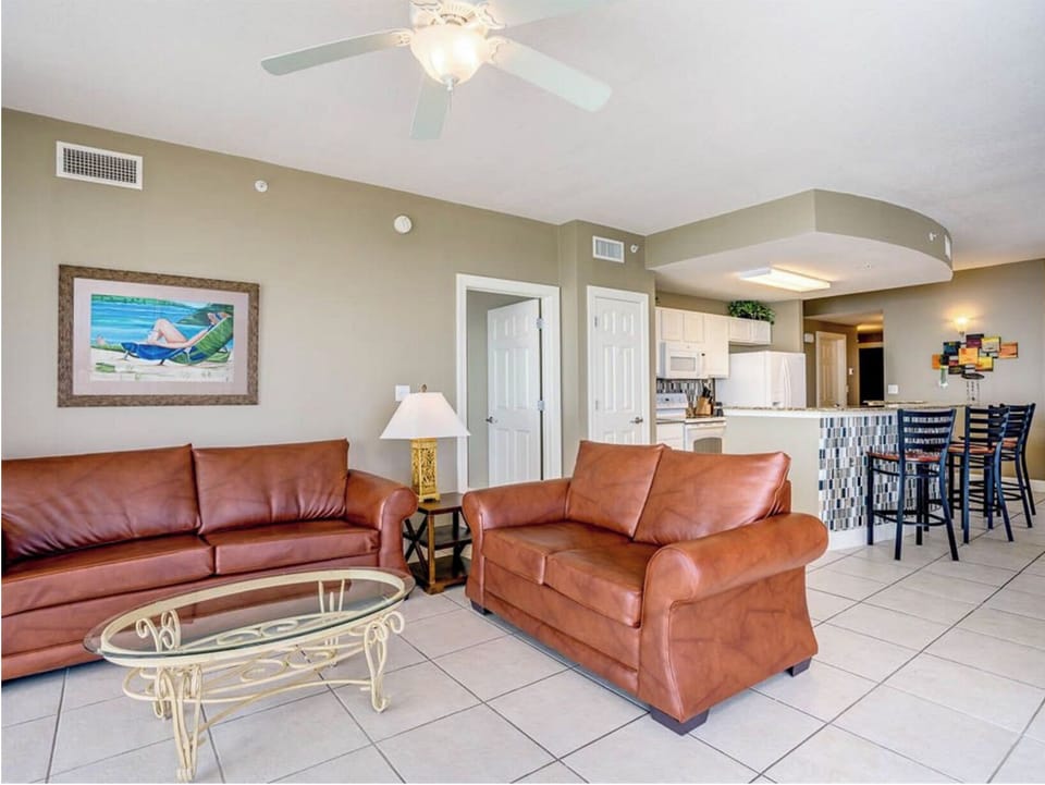 Relax in your spacious living room with plush leather seating, perfect for unwinding after beach days while enjoying the open layout.