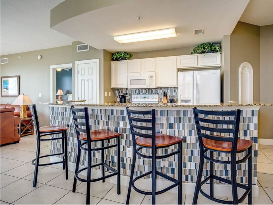 Gather with your group at the breakfast bar where stylish seating and modern design create the perfect spot for morning coffee or evening conversations.