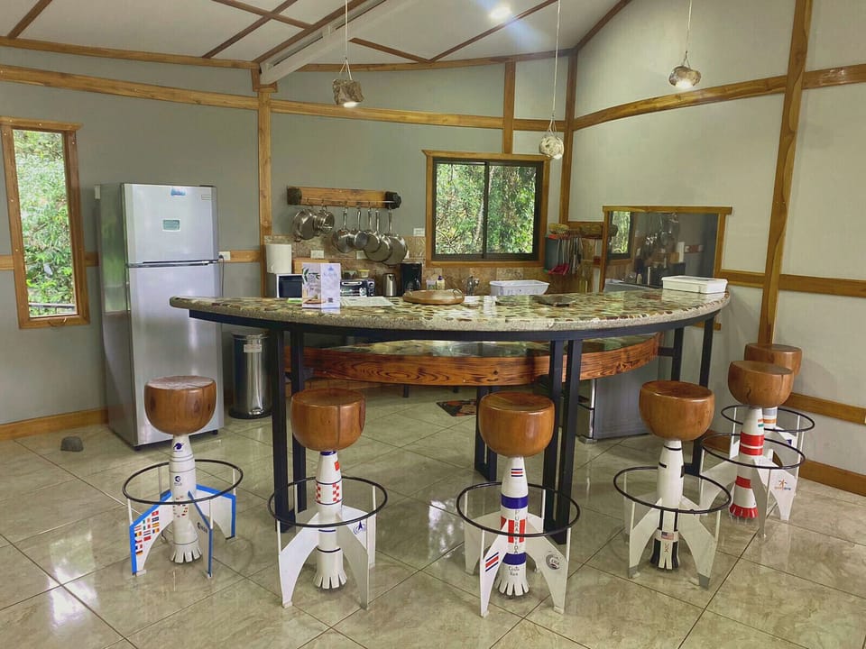 Kitchen and dining room with imitation rocket bar stools