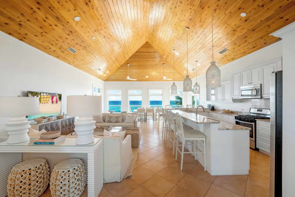Family Room with vaulted ceilings and tall windows allowing natural light and ocean views to fill the room. 