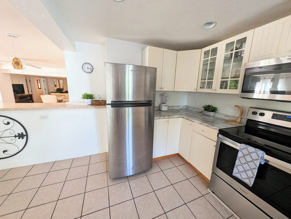 Full kitchen stocked with pots, pans, cooking utensils, etc.