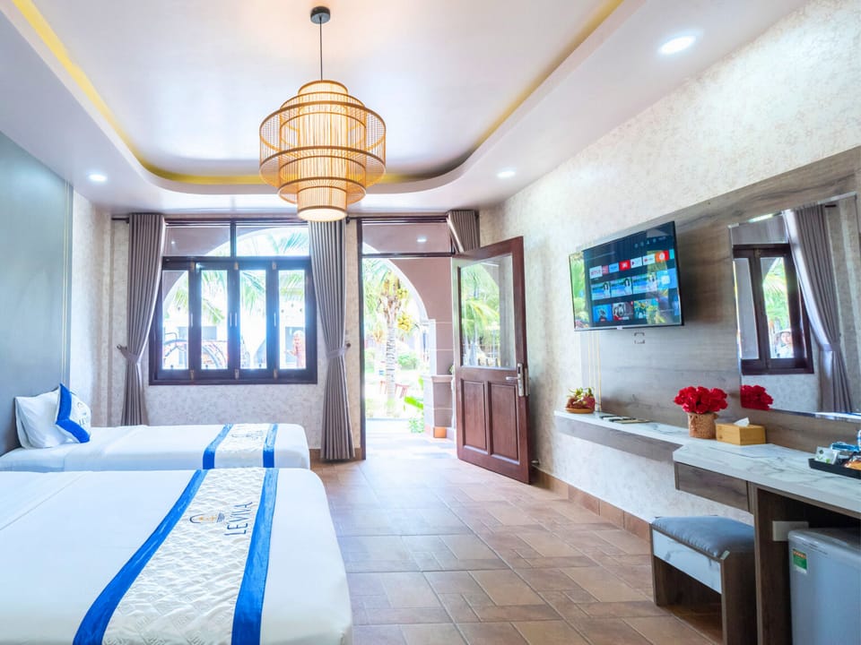 Deluxe Triple Room, Garden View | Minibar, in-room safe, desk, soundproofing