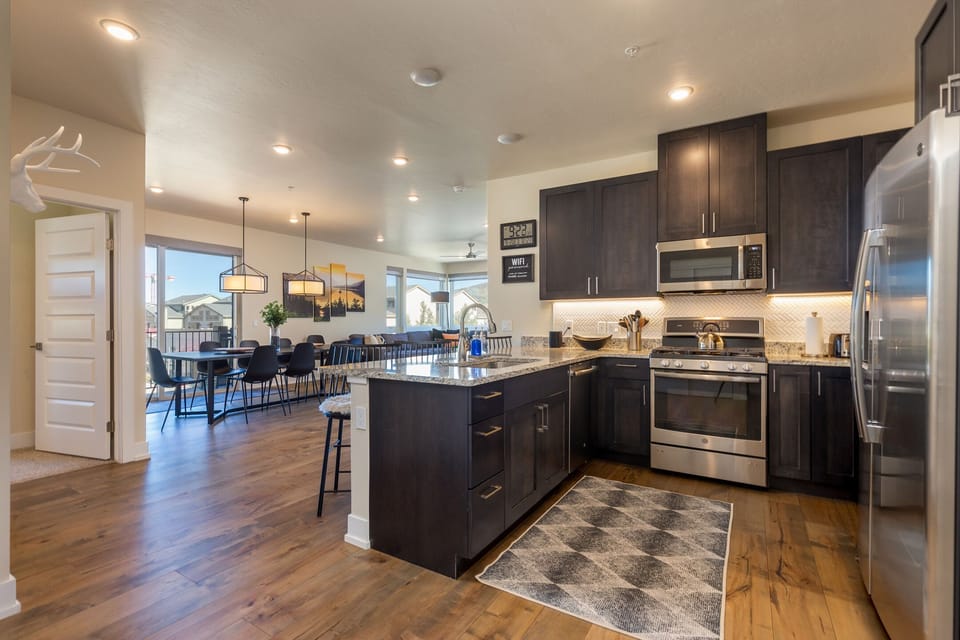 Your gourmet kitchen flows seamlessly into the dining area, featuring granite countertops and stainless steel appliances for effortless meal prep.
