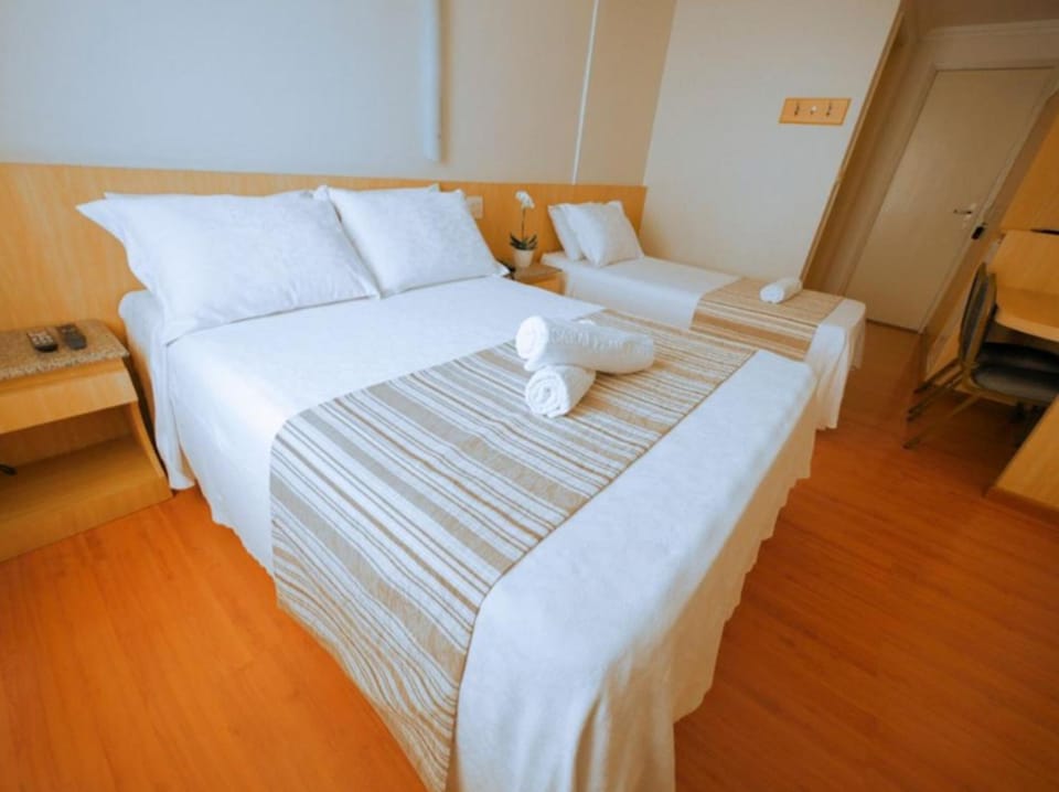 Standard Triple Room | Minibar, in-room safe, desk, blackout drapes