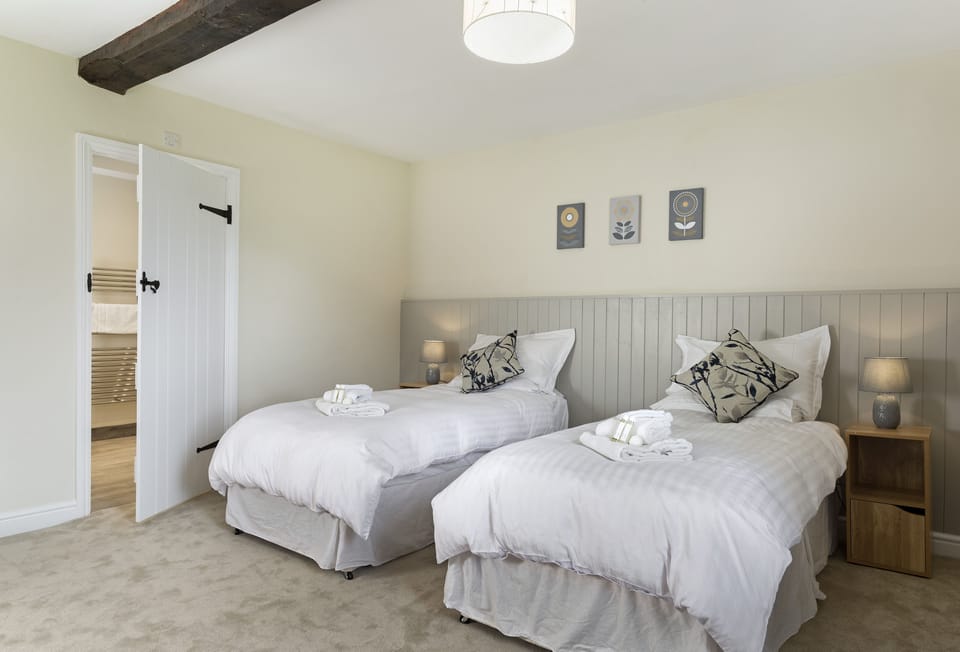 Ground floor: Bedroom with 6' super king size zip and link beds (configured as a twin) with en-suite shower