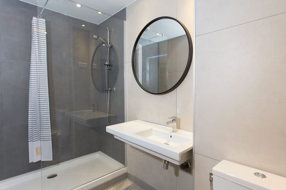 Shower, rainfall showerhead, hair dryer, towels