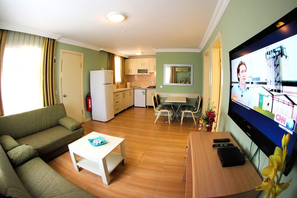 Family Apartment, 2 Bedrooms | Living room | 22-inch LCD TV with premium channels, TV