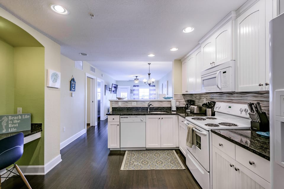 Kitchen - fully equipped - fridge, range, microwave, dishwasher, stackable washer/dryer