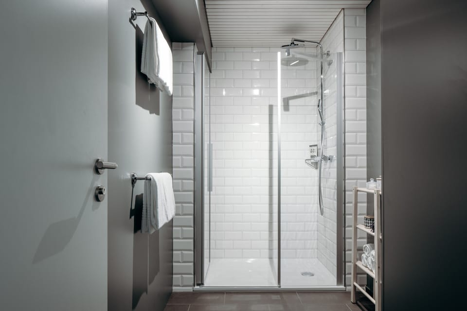 Studio Suite | Bathroom | Designer toiletries, hair dryer, bathrobes, slippers