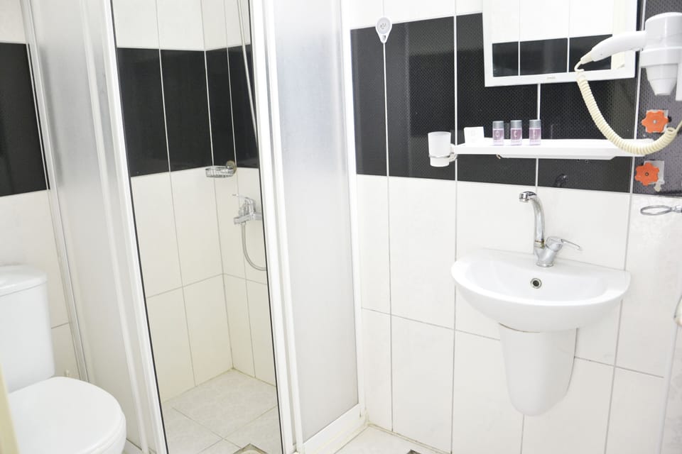 Second Floor Single Room Windowless | Bathroom | Shower, free toiletries, hair dryer, slippers