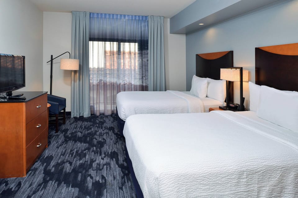 Premium bedding, desk, laptop workspace, blackout drapes
