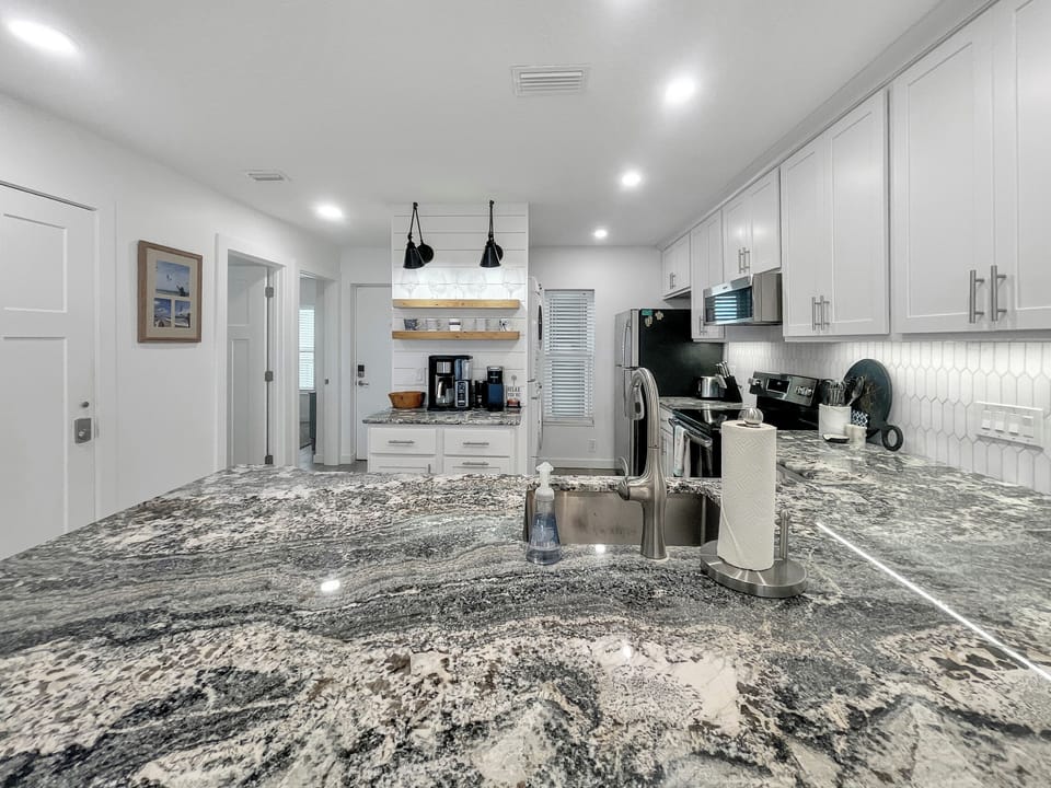 Broad view of kitchen and stunning granite countertops!