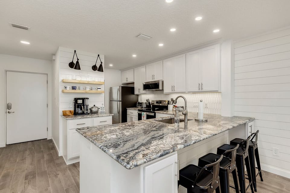 Large breakfast bar with 4 bar stools and stunning "Blue Wave" granite counters!