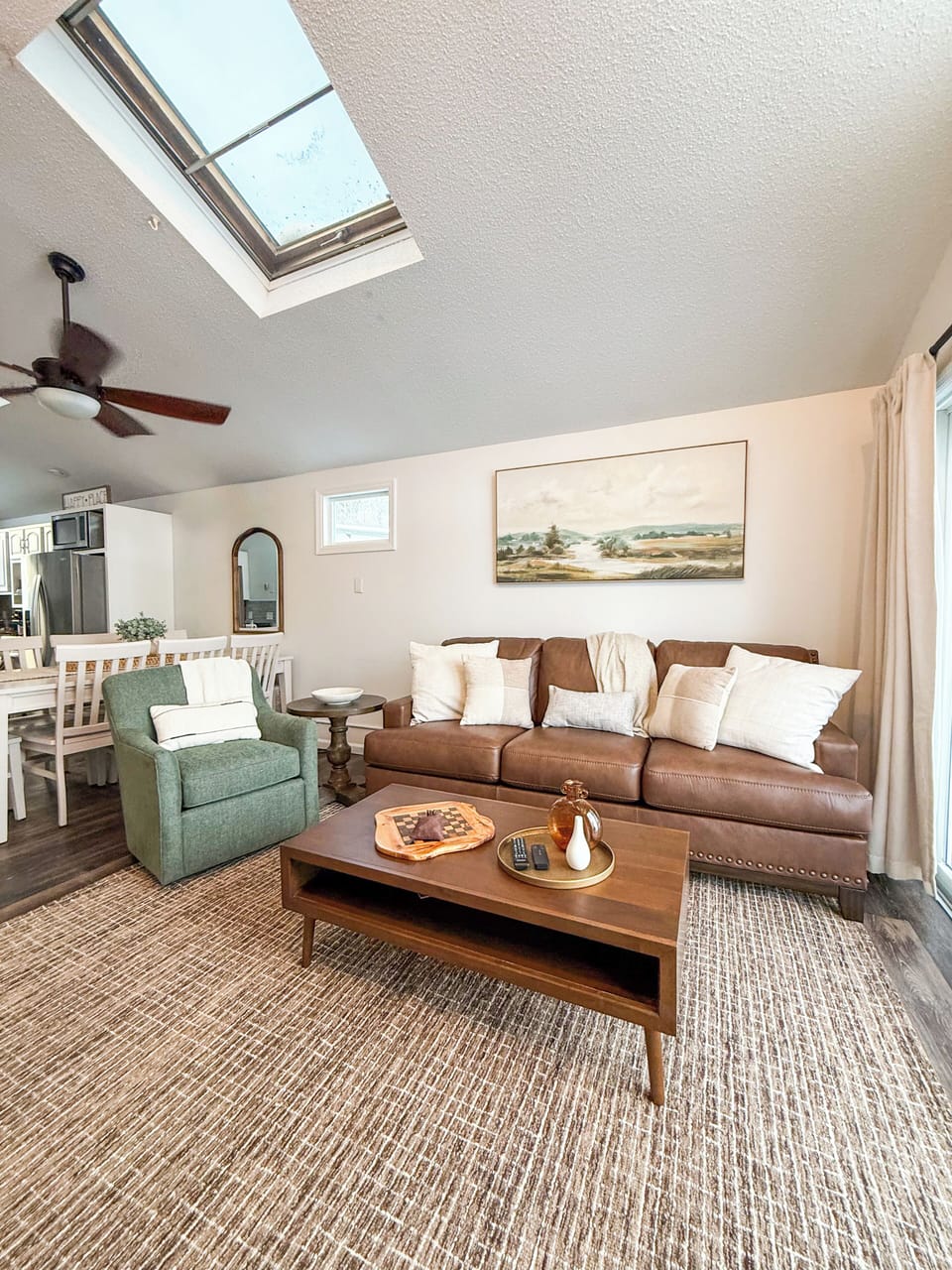 Main level, open-concept kitchen, dining, and living room areas.