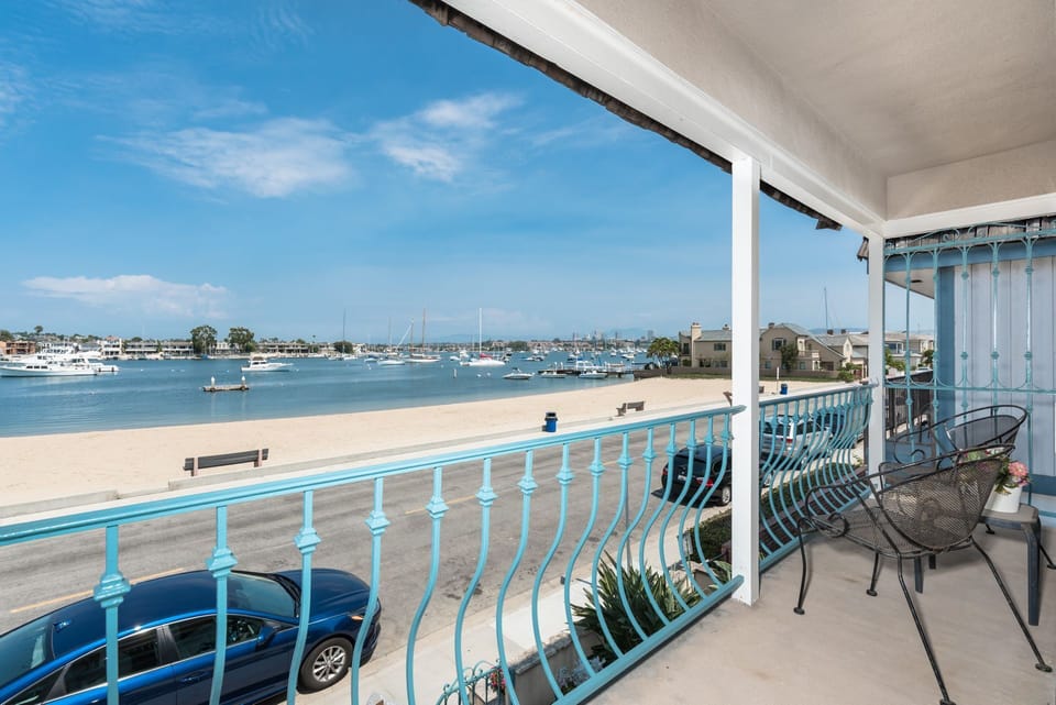 The primary bedroom's private balcony and its views of the bay.
                