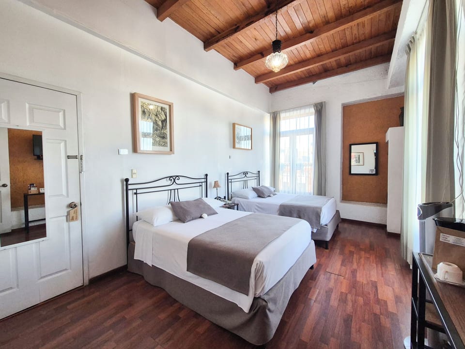 Standard Double Room, 2 Double Beds | Minibar, in-room safe, individually decorated, desk