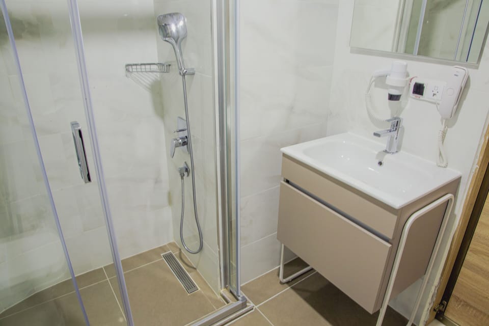 Shower, hair dryer, slippers, towels