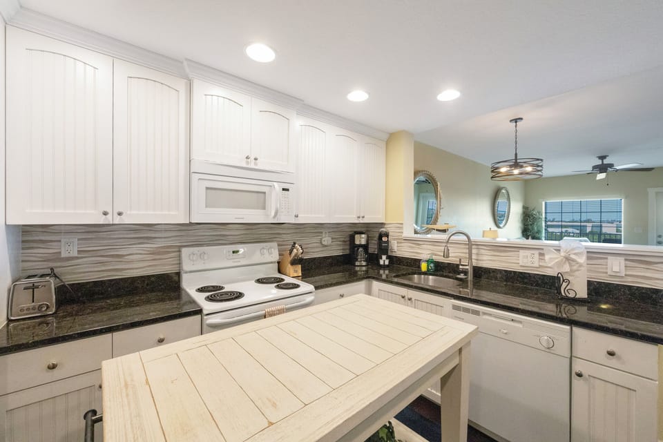 Kitchen - fully equipped w/ a microwave, dishwasher, full size fridge, Mr. Coffee, range, stackable washer/dryer, pots/pans, dishes and silverware.
