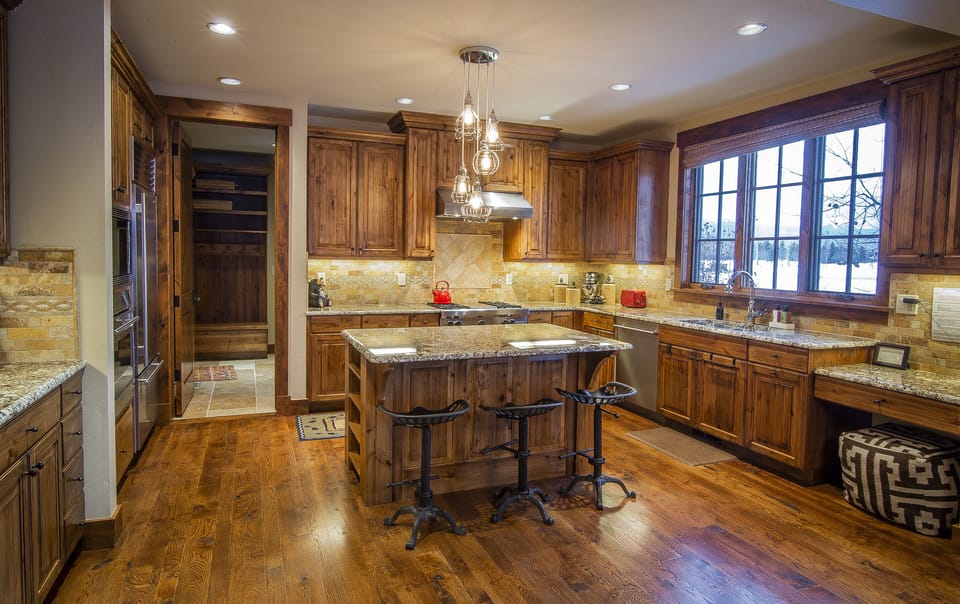 Your dream kitchen awaits with rich hardwood cabinets, gleaming granite countertops, and a spacious island perfect for morning coffee or evening wine. Natural light pours through beautiful windows while you cook.