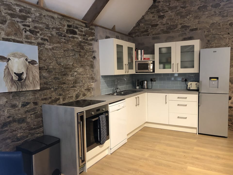 Kitchen with fridge/freezer, microwave, dishwasher and wine fridge.