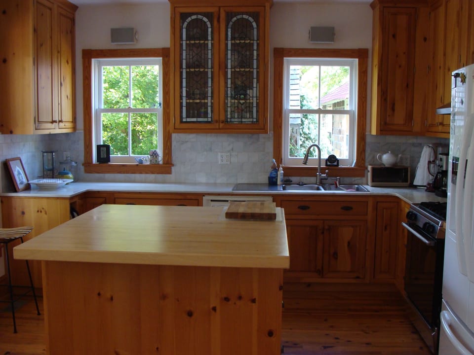 Gourmet kitchen featuring marble and wood counters with stained glass cupboard