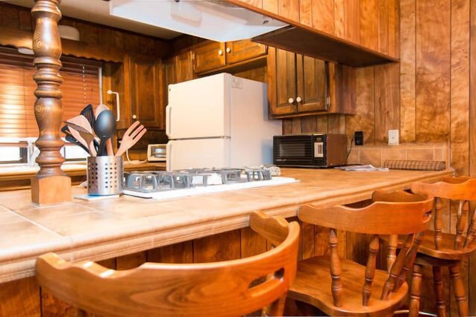 fully stocked kitchen with pots, pans and utensils