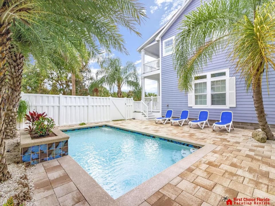 Private pool oasis with lush palm trees and sun loungers