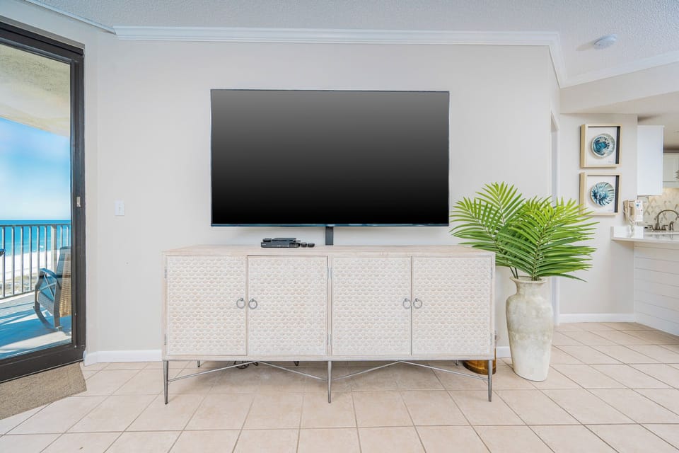 Enjoy the spacious living area with a large TV, stylish decor, and a view that enhances your relaxation experience