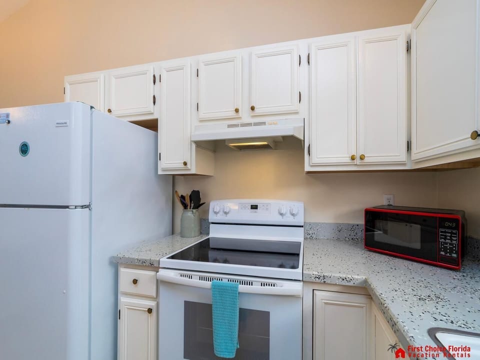 Bright, fully equipped kitchen with modern appliances and cozy charm