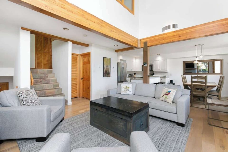 - Stylish open living space with exposed beams and soft natural light  
- Cozy seating area blending modern design with rustic touches  
- Spacious mountain home perfect for relaxing or entertaining  
