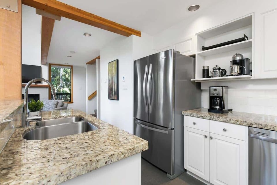 - Bright modern kitchen with dual sinks, granite counters, and full appliances  
- Sleek design blending mountain charm with everyday comfort  
- Perfect setup for group meals or cozy family breakfasts  