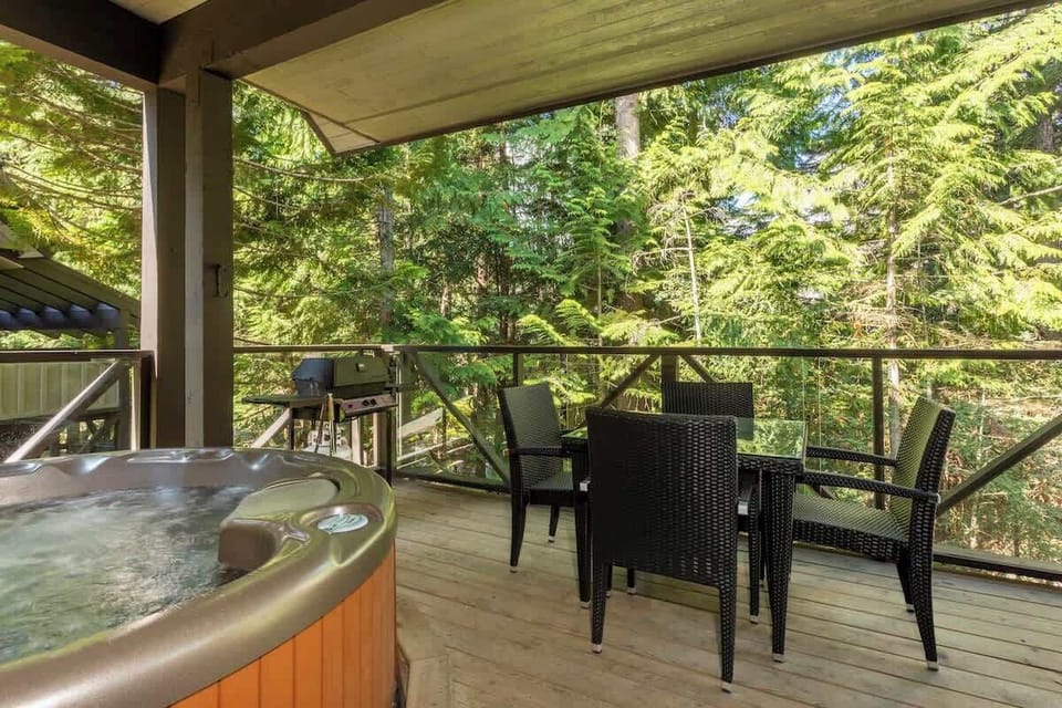 - Outdoor deck with hot tub and dining area  
- Surrounded by lush forest views for total relaxation  
- Great for barbecues and evening soaks under the trees  
