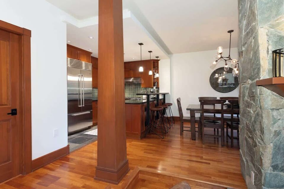 - Open layout connecting kitchen, dining, and living areas  
- Hardwood floors and rustic stone accents add alpine charm  
- Ideal for entertaining after a day on Whistler’s slopes  