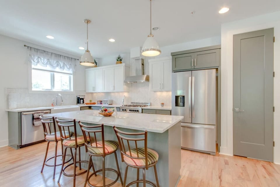 Kitchen with bar stools at the island and stainless steel appliances