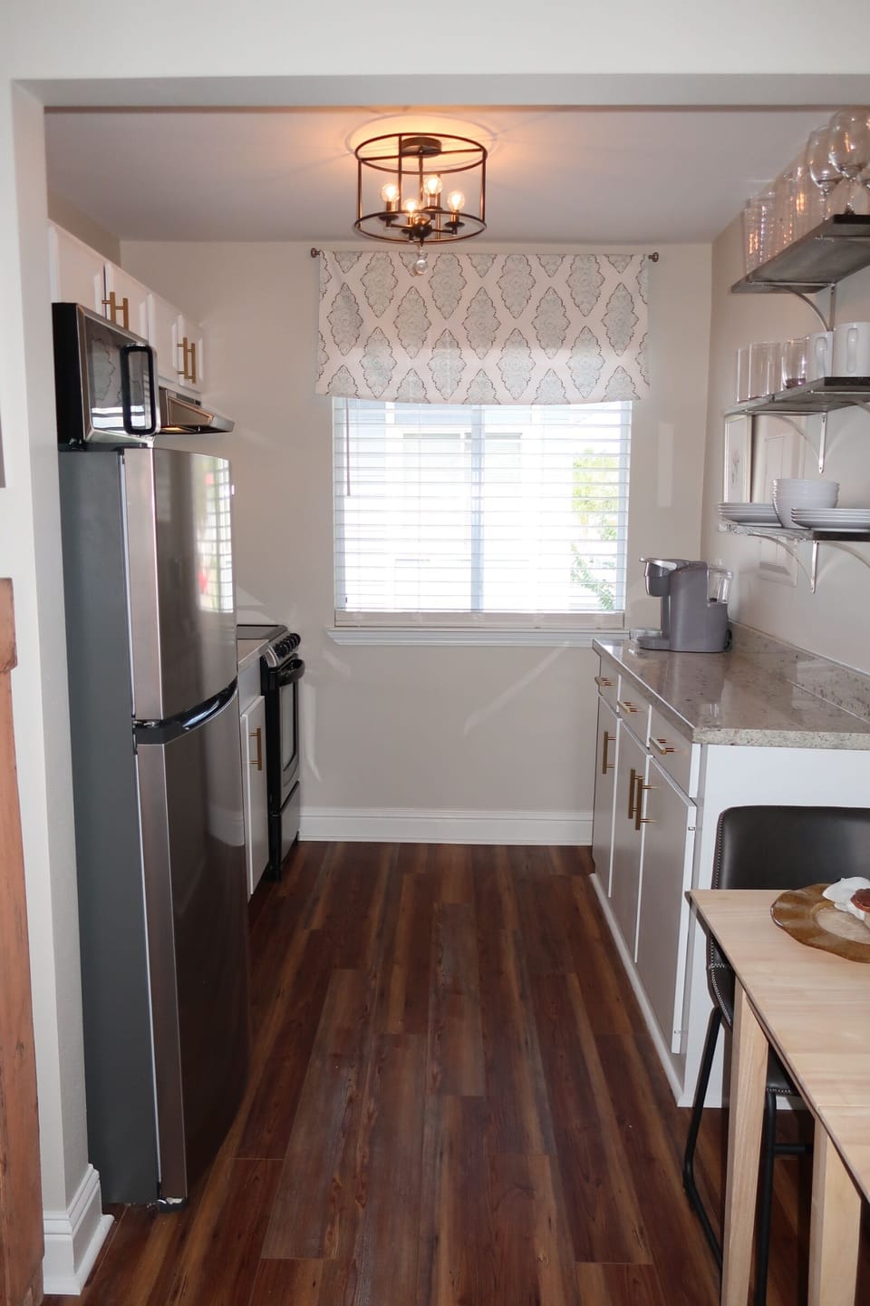New granite and stainless appliances in this renovated gourmet kitchen