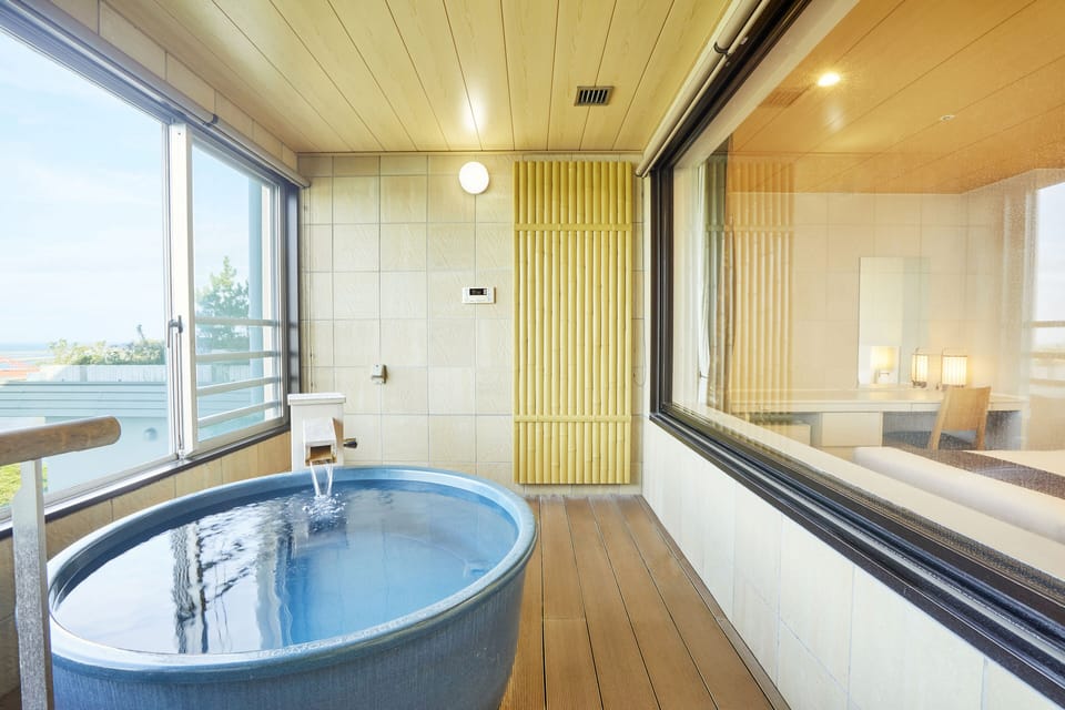 Deluxe Japanese-Western Room, Non Smoking (With Natural Hot Spring View bath) | Bathroom | Hair dryer, slippers, towels