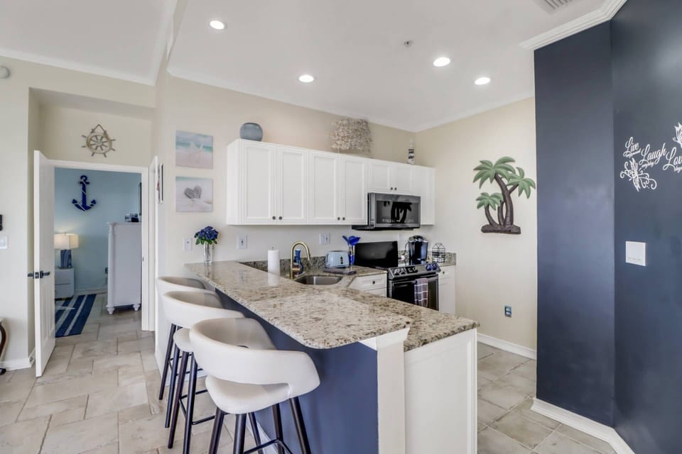 The beautifully remodeled open kitchen offers granite counters and full-size appliances.