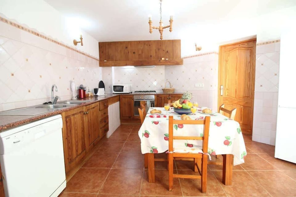 The main kitchen with dishwasher, coffee machine and more. Leads to small breakfast patio and utility room  