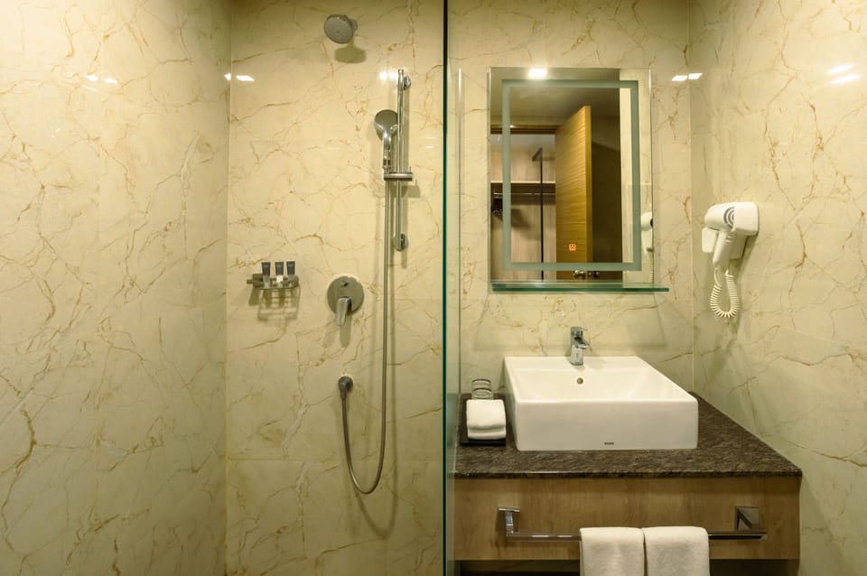 Deluxe Quadruple Room, 2 Queen Beds, Non Smoking | Bathroom | Shower, rainfall showerhead, hair dryer, bathrobes
