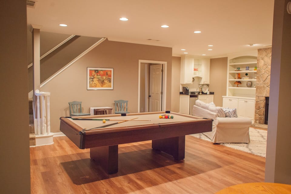 Downstairs living room with convertible pool/ping pong tablet, and kitchenette