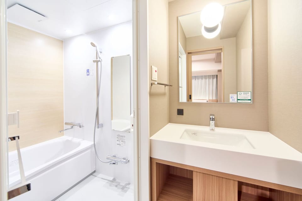 Twin Room, Non Smoking | Bathroom | Combined shower/tub, hair dryer, slippers, electronic bidet