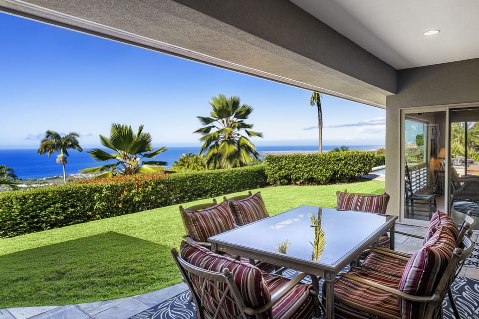 Al fresco dining on the lanai, with stunning views of the coastline and Pacific Ocean.