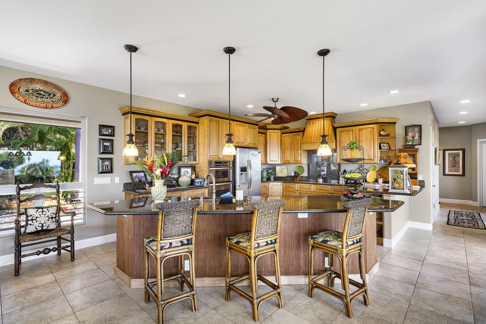 Gourmet kitchen with a spacious breakfast bar, perfect for casual meals and conversation.