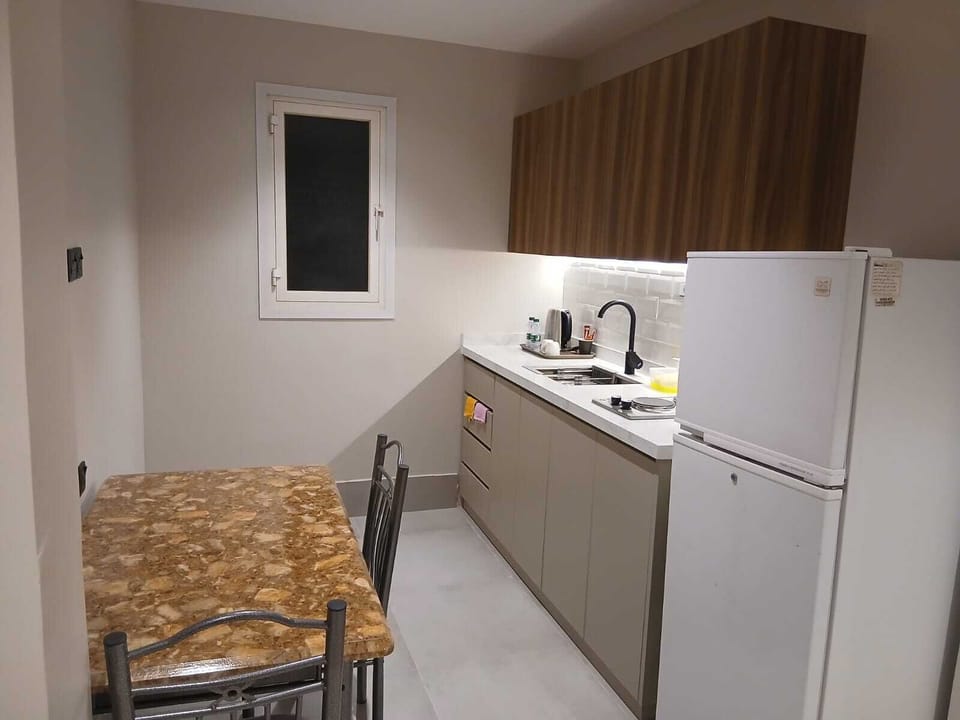 Fridge, electric kettle, cookware/dishes/utensils