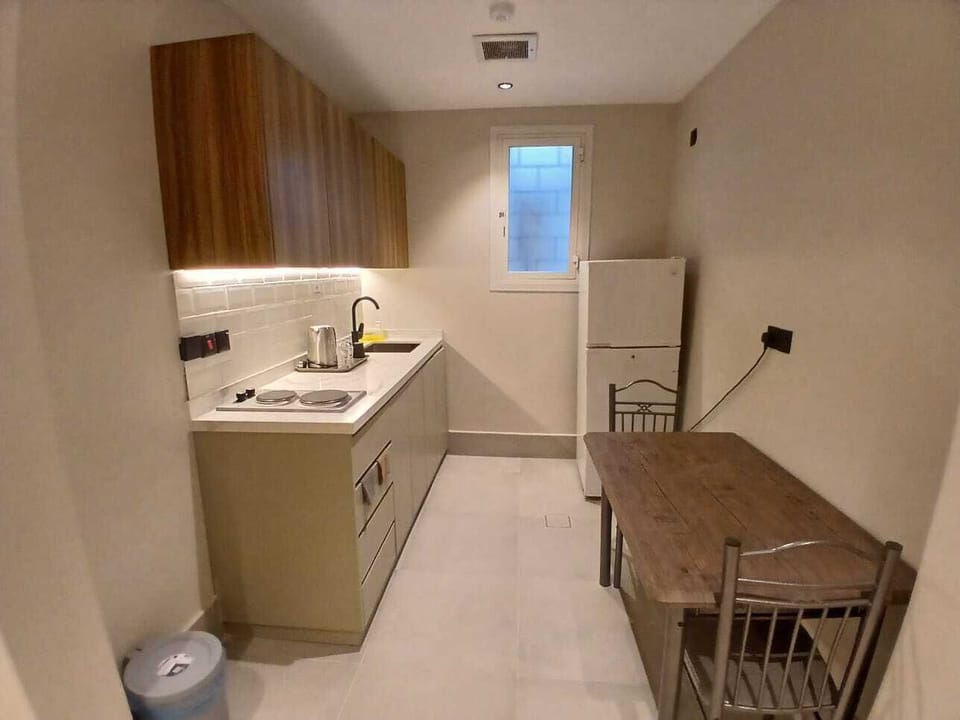 Fridge, electric kettle, cookware/dishes/utensils
