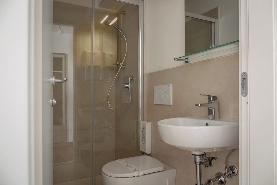 Basic Single Room, 1 Twin Bed, Courtyard Area | Bathroom | Shower, hair dryer, towels, soap
