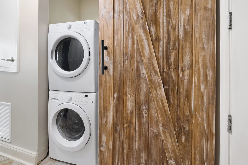Your own washer and dryer await behind rustic barn doors, making longer stays effortless and comfortable.
