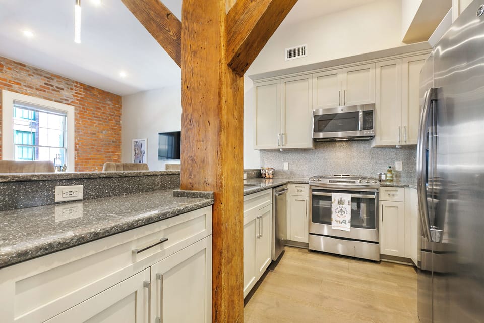 Cook and dine easily in the fully stocked kitchen, equipped with all stainless steel appliances, gas range, basic cookware, and a dining area for a comfortable meal at home. Entertain at the bar with seating for four.